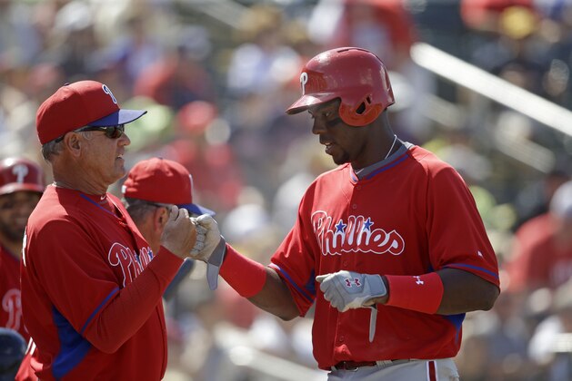 Philadelphia Phillies John Mayberry Jr. is greeted by manager Ryne Sandberg after scoring the tying run in the eighth inning of an exhibition baseball game against the Minnesota Twins in Fort Myers, Fla., Sunday, March 9, 2014. The game ended in a 1-1 tie. (AP Photo/Gerald Herbert)