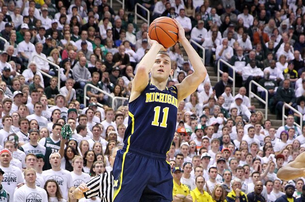 Jan 25, 2014; East Lansing, MI, USA; Michigan Wolverines guard Nik Stauskas (11) attempts to shoot a three point basket against the Michigan State Spartans during the 1st half of a game at Jack Breslin Student Events Center. Mandatory Credit: Mike Carter-USA TODAY Sports