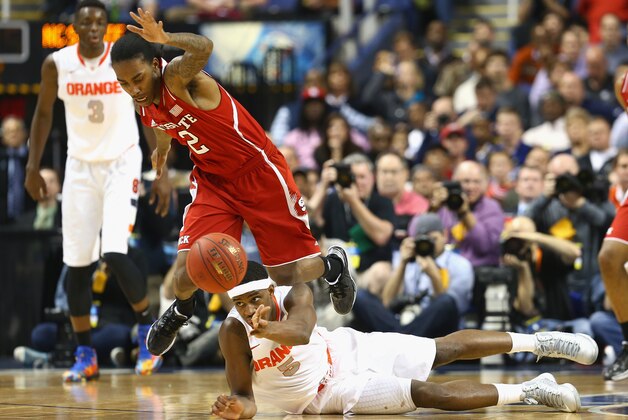 GREENSBORO, NC - MARCH 14:  C.J. Fair #5 of the Syracuse Orange and Anthony Barber #2 of the North Carolina State Wolfpack go after a loose ball during the quarterfinals of the 2014 Men's ACC Basketball Tournament at Greensboro Coliseum on March 14, 2014 in Greensboro, North Carolina.  (Photo by Streeter Lecka/Getty Images)