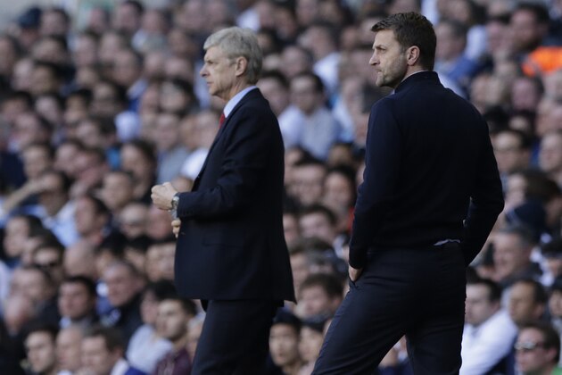 Tottenham Hotspur's manager Tim Sherwood, right, watches his players as Arsenal's manager Arsene Wenger looks on during the English Premier League soccer match between Tottenham Hotspur and Arsenal at White Hart Lane stadium in London, Sunday, March 16, 2014. (AP Photo/Matt Dunham)