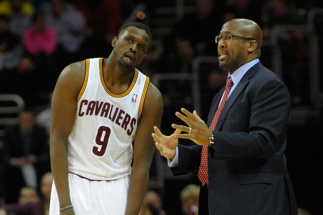 Feb 11, 2014; Cleveland, OH, USA; Cleveland Cavaliers head coach Mike Brown (right) talks with small forward Luol Deng (9) against the Sacramento Kings at Quicken Loans Arena. Cleveland won 109-99. Mandatory Credit: David Richard-USA TODAY Sports