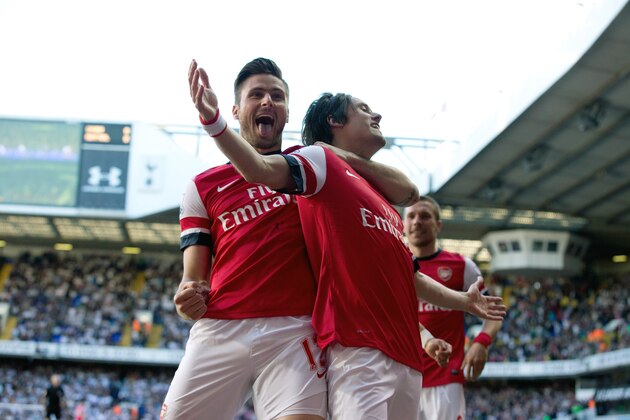 Arsenal's Tomas Rosicky, right, celebrates scoring with teammate Olivier Giroud during the English Premier League soccer match between Tottenham Hotspur and Arsenal at White Hart Lane stadium in London, Sunday, March 16, 2014. (AP Photo/Matt Dunham)