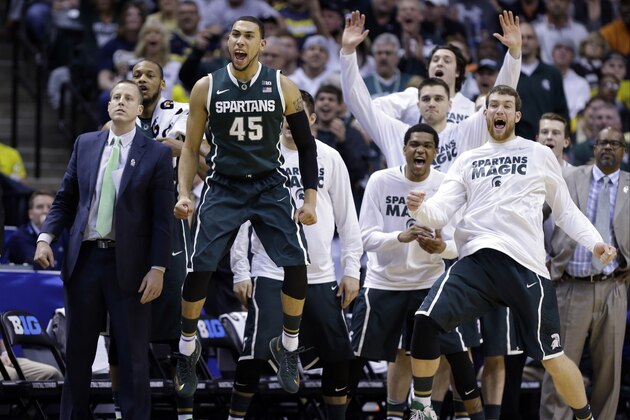Players on the Michigan State bench react in the second half of an NCAA college basketball game against Michigan in the championship of the Big Ten Conference tournament on Sunday, March 16, 2014, in Indianapolis. (AP Photo/Michael Conroy)