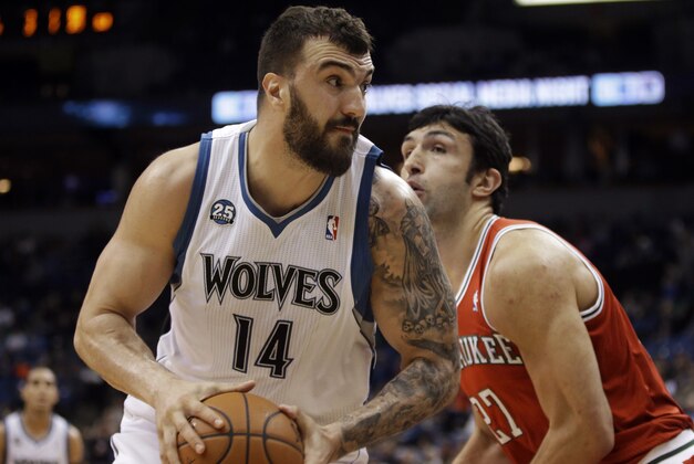 Minnesota Timberwolves' Nikola Pekovic, left, of Montenegro, is closely watched by Milwaukee Bucks' Zaza Pachulia of Georgia in the first quarter of an NBA basketball game, Tuesday, March 11, 2014, in Minneapolis. (AP Photo/Jim Mone)
