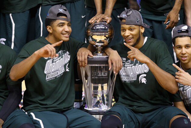 INDIANAPOLIS, IN - MARCH 16:   Gary Harris #14 and Adreian Payne #5 of the Michigan State Spartans celebrates after the 69-55 win over the Michigan Wolverines  during the finals of the Big Ten Basketball Tournament at Bankers Life Fieldhouse on March 16, 2014 in Indianapolis, Indiana.  (Photo by Andy Lyons/Getty Images)