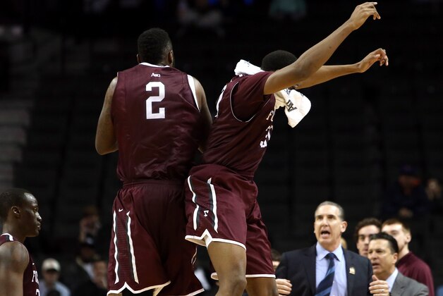NEW YORK, NY - MARCH 12: Travion Leonard #2 and Ryan Rhoomes #30 of the Fordham Rams celebrate after a shot by Leonard in the second half against the George Mason Patriots during the first round of the Atlantic 10 Men's Basketball Tournament at Barclays Center on March 12, 2014 in the Brooklyn Borough of New York City.  (Photo by Mike Lawrie/Getty Images)