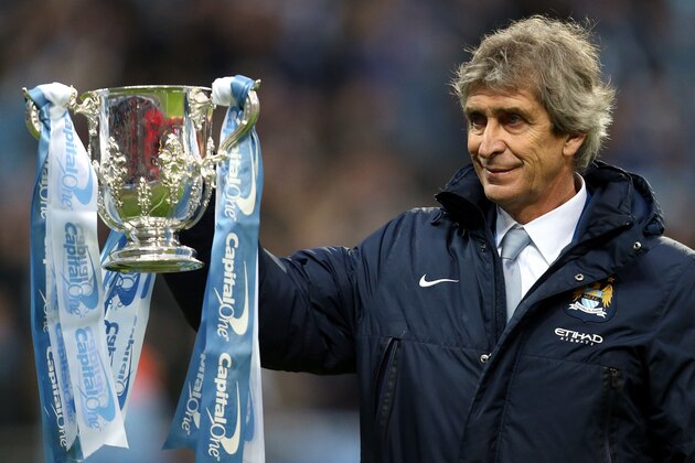 Manchester City's manager Manuel Pellegrini holds the League Cup Trophy after their English League Cup final soccer match against Sunderland at Wembley Stadium, London, England, Sunday, March 2, 2014. (AP Photo/Scott Heppell)