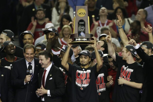Louisville guard Peyton Siva (3) holds the winning trophy with his team mates after Louisville defeated Michigan after the second half of the NCAA Final Four tournament college basketball championship game Tuesday, April 9, 2013, in Atlanta. Louisville won 82-76. (AP Photo/Chris O'Meara)
