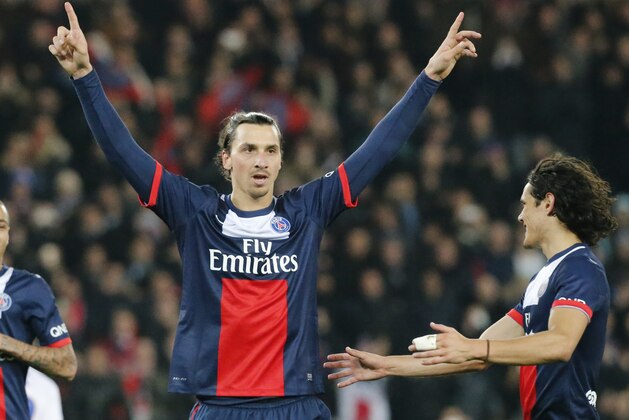 Paris Saint Germain's Zlatan Ibrahimovic of Sweden, and Edinson Cavani, right, celebrate after a goal against Lyon during their  French Premier League soccer match Sunday Dec. 1, 2013, in Parc des Princes stadium, in Paris, France. (AP Photo/Jacques Brinon)
