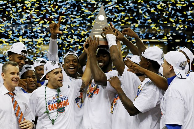 ATLANTA, GA - MARCH 16:  The Florida Gators celebrate with the trophy after their 61 to 60 win over the Kentucky Wildcats in the Championship game of the 2014 Men's SEC Basketball Tournament at Georgia Dome on March 16, 2014 in Atlanta, Georgia.  (Photo by Kevin C. Cox/Getty Images)