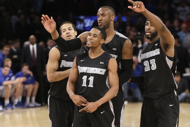 Providence's Bryce Cotton (11) and LaDontae Henton (23) celebrate with teammates during the second half of an NCAA college basketball game against Creighton in the final of the Big East Conference men's tournament Saturday, March 15, 2014, at Madison Square Garden in New York. Providence won 65-58. (AP Photo/Frank Franklin II)
