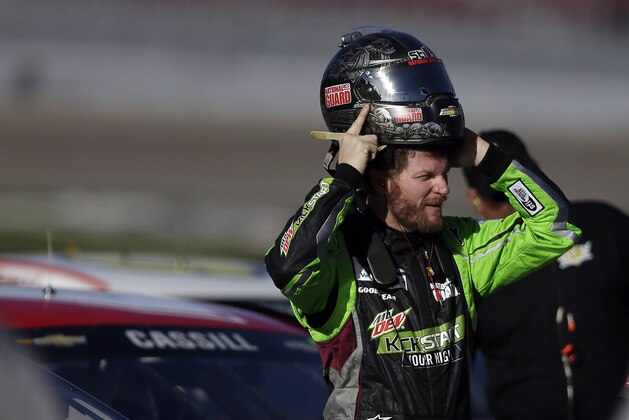 Dale Earnhardt Jr. puts on his helmet during qualifying for Sunday's NASCAR Sprint Cup Series auto race on Friday, March 7, 2014, in Las Vegas. (AP Photo/Isaac Brekken)