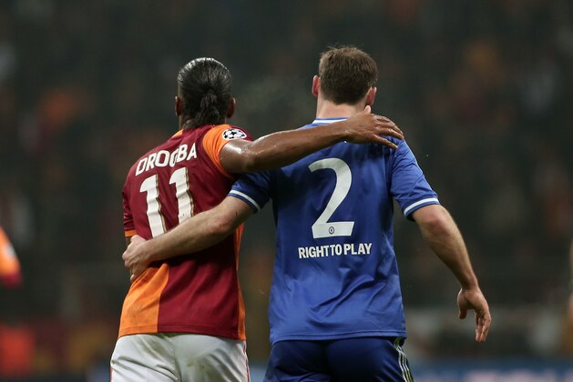 Former Chelsea star, Didier Drogba of Galatasaray, left, and Branislav Ivanovic of Chelsea during their Champions League Round of 16, First Leg match between Galatasaray and Chelsea at Turk Telekom Arena Stadium in Istanbul, Turkey, Wednesday, Feb. 26, 2014. (AP Photo/Emrah Gurel)
