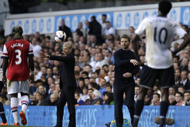 Tottenham Hotspur's manager Tim Sherwood, second right thaws the ball back onto the pitch during the English Premier League soccer match between Tottenham Hotspur and Arsenal at White Hart Lane stadium in London, Sunday, March 16, 2014. (AP Photo/Matt Dunham)