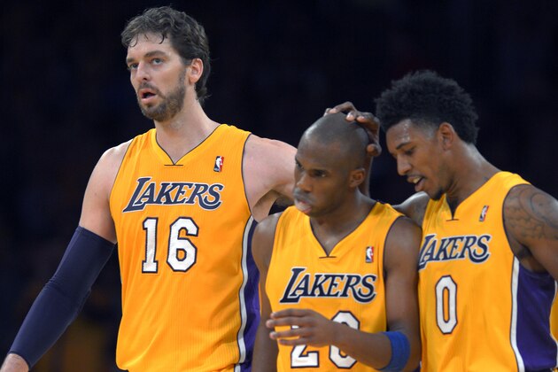 Los Angeles Lakers center Pau Gasol, left, of Spain, guard Jodie Meeks, center, and forward Nick Young celebrate in the closing seconds of an NBA basketball game against the Utah Jazz, Friday, Jan. 3, 2014, in Los Angeles. (AP Photo/Mark J. Terrill)