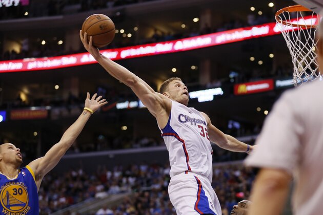 Los Angeles Clippers' Blake Griffin dunks the ball on a rebound in front of Golden State Warriors Stephen Curry, left, during the second half of an NBA basketball game in Los Angeles, Wednesday, March 12, 2014. The Clippers won 111-98. (AP Photo/Danny Moloshok)