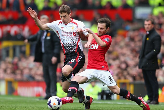MANCHESTER, ENGLAND - MARCH 16:  Jon Flanagan of Liverpool competes with Juan Mata of Manchester United during the Barclays Premier League match between Manchester United and Liverpool at Old Trafford on March 16, 2014 in Manchester, England.  (Photo by Alex Livesey/Getty Images)