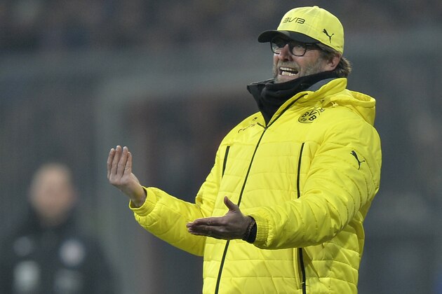 Dortmund head coach Juergen Klopp coaches from the line during the German Bundesliga soccer match between Eintracht Braunschweig and Borussia Dortmund in Braunschweig,  Germany, Friday, Jan. 31, 2014. (AP Photo/Martin Meissner)