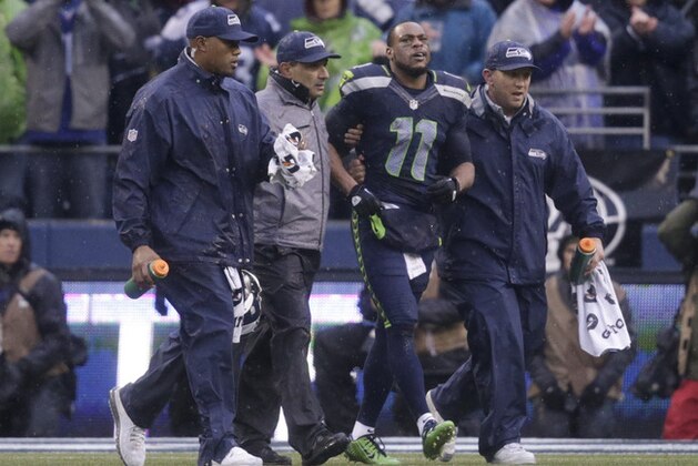 Seattle Seahawks wide receiver Percy Harvin (11) is helped off the field after being injured during the second quarter of an NFC divisional playoff NFL football game against the New Orleans Saints in Seattle, Saturday, Jan. 11, 2014. (AP Photo/John Froschauer)
