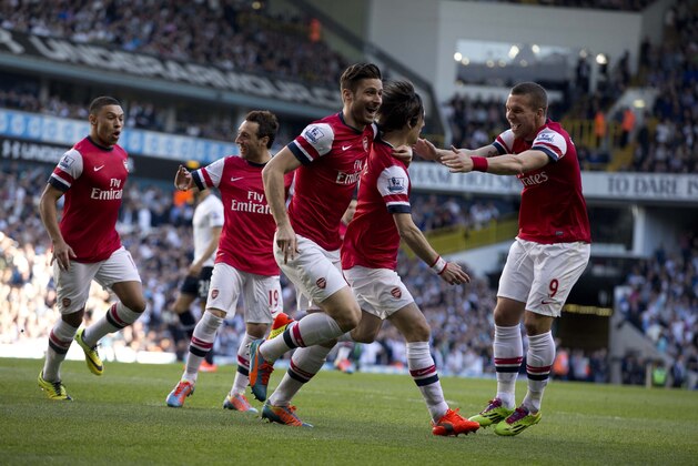 Arsenal's Tomas Rosicky, second right, celebrates scoring with his teammates during the English Premier League soccer match between Tottenham Hotspur and Arsenal at White Hart Lane stadium in London, Sunday, March 16, 2014. (AP Photo/Matt Dunham)