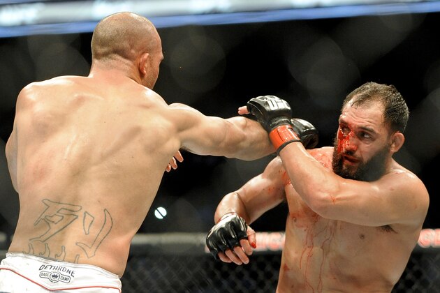 Johny Hendricks blocks a punch from Robbie Lawler during a UFC 171 mixed martial arts welterweight title bout, Saturday, March 15, 2014, in Dallas. Hendricks won by decision. (AP Photo/Matt Strasen)