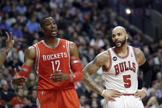 Houston Rockets forward Dwight Howard (12) talks to teammates during the second half of an NBA basketball game against the Chicago Bulls in Chicago on Thursday, March 13, 2014. The Bulls won 111-87. (AP Photo/Nam Y. Huh)