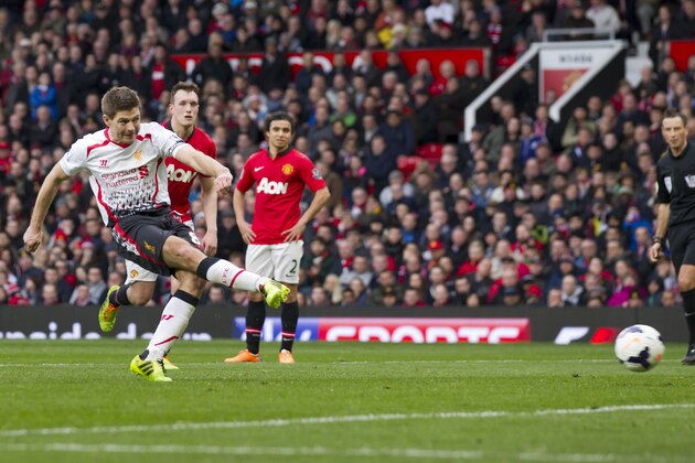 Liverpool's Steven Gerrard, right, fails to score his third penalty against Manchester United during their English Premier League soccer match at Old Trafford Stadium, Manchester, England, Sunday March 16, 2014. (AP Photo/Jon Super)