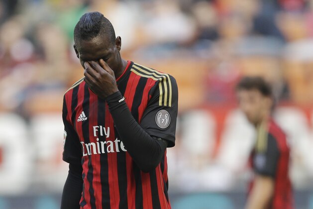 AC Milan forward Mario Balotelli touches his eyes during a Serie A soccer match between AC Milan and Parma, at the San Siro stadium in Milan, Italy, Sunday, March 16, 2014. Parma won 4-2. (AP Photo/Luca Bruno)
