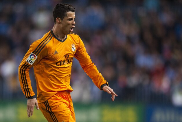 Real Madrid's Cristiano Ronaldo celebrates scoring the opening goal during a Spanish La Liga soccer match at La Rosaleda stadium in Malaga, Spain, Saturday March 15, 2014. (AP Photo/Daniel Tejedor)