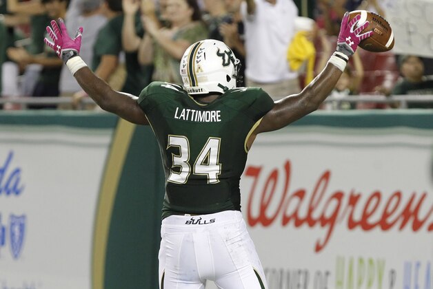 Oct 5, 2013; Tampa, FL, USA; South Florida Bulls linebacker Devekeyan Lattimore (34) reacts after he scored a touchdown as he recovered a fumble against the Cincinnati Bearcats  during the second quarter at Raymond James Stadium. Mandatory Credit: Kim Klement-USA TODAY Sports