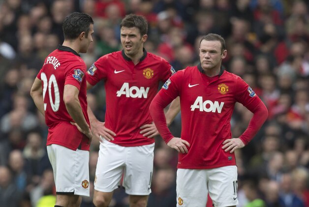 Manchester United's Wayne Rooney, right, Michael Carrick, centre, and Robin van Persie wait for play to restart after Liverpool's first goal during their English Premier League soccer match at Old Trafford Stadium, Manchester, England, Sunday March 16, 2014. Liverpool won the game 3-0. (AP Photo/Jon Super) Manchester United's Wayne Rooney, right, Michael Carrick, centre, and Robin van Persie wait for play to restart after Liverpool's first goal during their English Premier League soccer match at Old Trafford Stadium, Manchester, England, Sunday March 16, 2014. Liverpool won the game 3-0. (AP Photo/Jon Super)