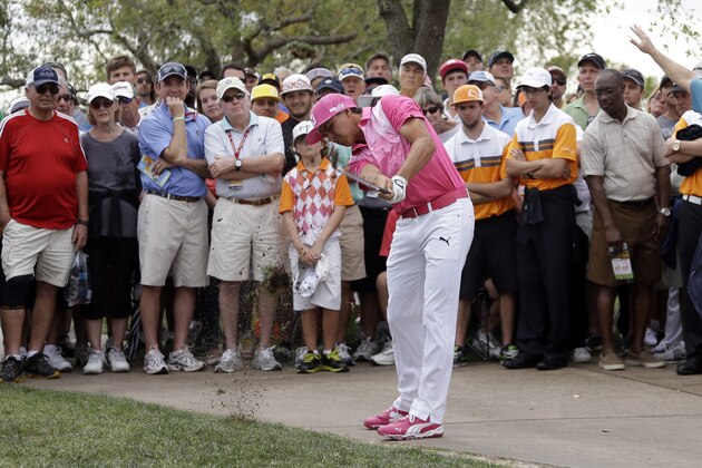 Rickie Fowler hits from out of bounds onto the sixth fairway during the first round of the Honda Classic golf tournament, Thursday, Feb. 27, 2014, in Palm Beach Gardens, Fla. (AP Photo/Lynne Sladky)