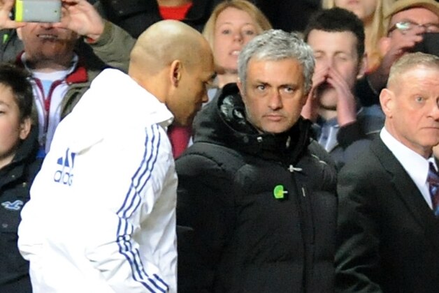 Chelsea manager Jose Mourinho, center right, walks back to dressing rooms after being sent off  during the English Premier League soccer match between Aston Villa and Chelsea at Villa Park, Birmingham, England, Saturday, March 15, 2014.  (AP Photo/Rui Vieira)