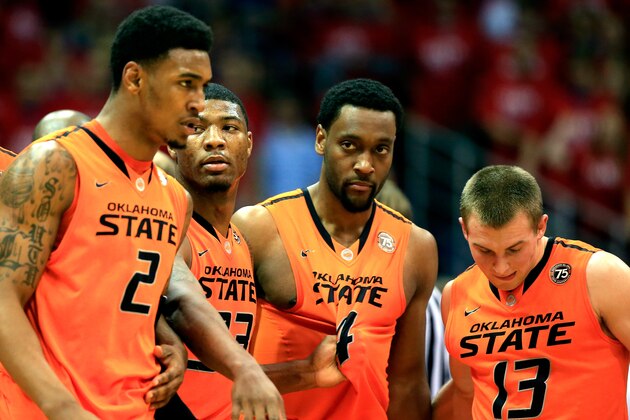 LAWRENCE, KS - JANUARY 18:  Le'Bryan Nash #2, Marcus Smart #33, Brian Williams #4, and Phil Forte, III #13 of the Oklahoma State Cowboys walk back upcourt after a foul during the game against the Kansas Jayhawks at Allen Fieldhouse on January 18, 2014 in Lawrence, Kansas.  (Photo by Jamie Squire/Getty Images)
