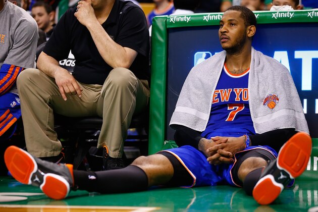 BOSTON, MA - MARCH 12: Carmelo Anthony #7 of the New York Knicks sits on the floor near the bench near the end of the game against the Boston Celtics during the game at TD Garden on March 12, 2014 in Boston, Massachusetts. NOTE TO USER: User expressly acknowledges and agrees that, by downloading and or using this photograph, User is consenting to the terms and conditions of the Getty Images License Agreement.  (Photo by Jared Wickerham/Getty Images)