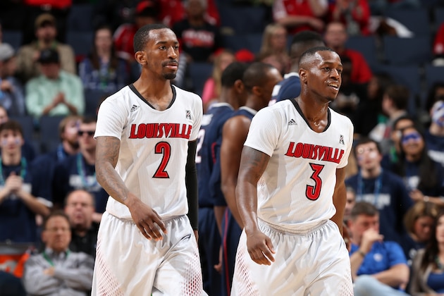 MEMPHIS, TN - MARCH 15: Russ Smith #2 and Chris Jones #3 of the Louisville Cardinals walk towards the bench against the Connecticut Huskies during the Championship of the American Athletic Conference Tournament at FedExForum on March 15, 2014 in Memphis, Tennessee. Louisville defeated Connecticut 71-61. (Photo by Joe Murphy/Getty Images)