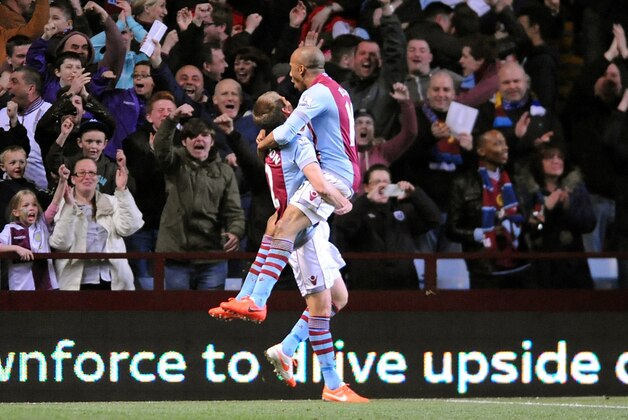 Aston Villa's  Fabian Delph, right, celebrates after scoring against Chelsea during the English Premier League soccer match between Aston Villa and Chelsea at Villa Park, Birmingham, England, Saturday, March 15, 2014.  (AP Photo/Rui Vieira)
