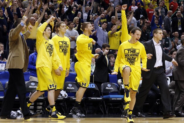 Mar 15, 2014; Indianapolis, IN, USA; Michigan Wolverines bench celebrates the victory after the game against the Ohio State Buckeyes in the semifinals of the Big Ten college basketball tournament at Bankers Life Fieldhouse. Michigan defeats Ohio State 72-69. Mandatory Credit: Brian Spurlock-USA TODAY Sports