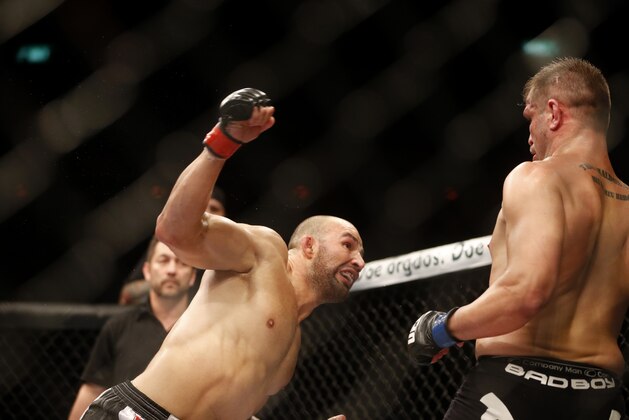 Glover Teixeira, left, from Brazil, takes a swing at Fabio Maldonado, right, from Brazil, during their heavyweight mixed martial arts bout at the Ultimate Fighting Championship (UFC) 153 in Rio de Janeiro, Brazil, Sunday Oct.  14, 2012. Teixeira defeated Maldonado. (AP Photo/Felipe Dana)
