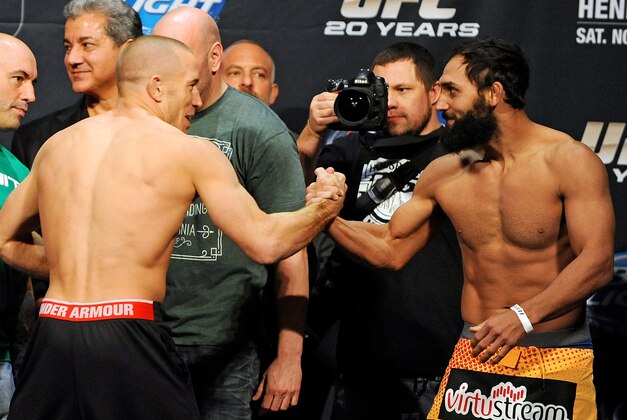 Nov 15, 2013; Las Vegas, NV, USA; UFC welterweight champion Georges St. Pierre shakes hands with welterweight challenger Johny Hendricks during the weigh-in of UFC 167 at MGM Grand Garden Arena. Mandatory Credit: Stephen R. Sylvanie-USA TODAY Sports