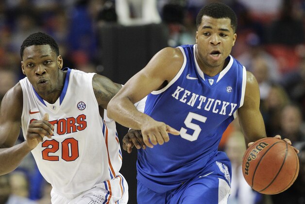 Kentucky guard Andrew Harrison (5) runs on Florida guard Michael Frazier II (20) during the first half of an NCAA college basketball game in the Championship round of the Southeastern Conference men's tournament, Sunday, March 16, 2014, in Atlanta. (AP Photo/Steve Helber)