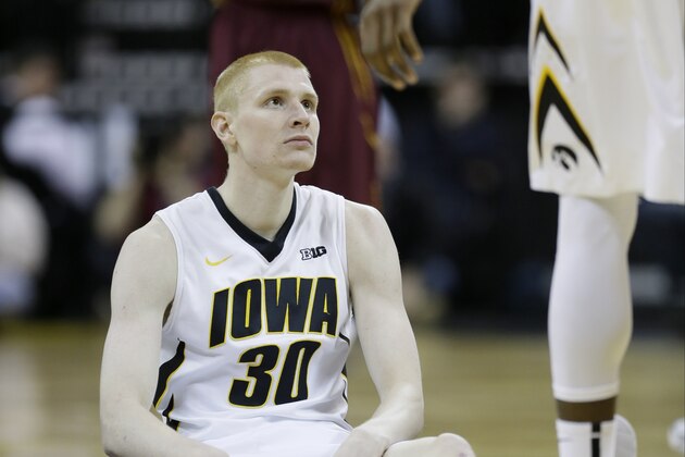 Iowa forward Aaron White sits on the court after being called for a foul during the first half of an NCAA college basketball game against Minnesota, Sunday, Jan. 19, 2014, in Iowa City, Iowa. (AP Photo/Charlie Neibergall)