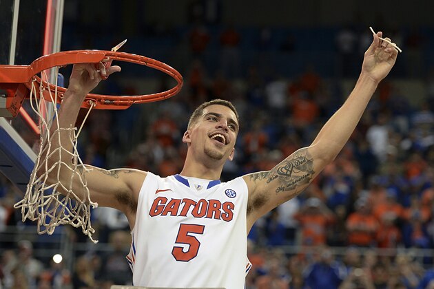Florida guard Scottie Wilbekin (5) holds up a piece of the net after the Gators became the first team in Southeastern Conference history to go 18-0 in league pla, Saturday, March 8, 2014 in Gainesville, Fla.    Florida defeated Kentucky 84-65 Saturday in an NCAA college basketball game. (AP Photo/Phil Sandlin)