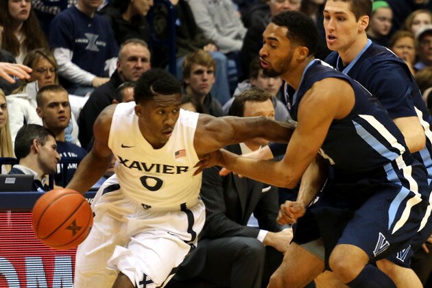 Xavier's Semaj Christon tries to get past Villanova's Darrun Hilliard in the first half of their NCAA college basketball game in Cincinnati Thursday March 6, 2014. (AP Photo/Tom Uhlman)