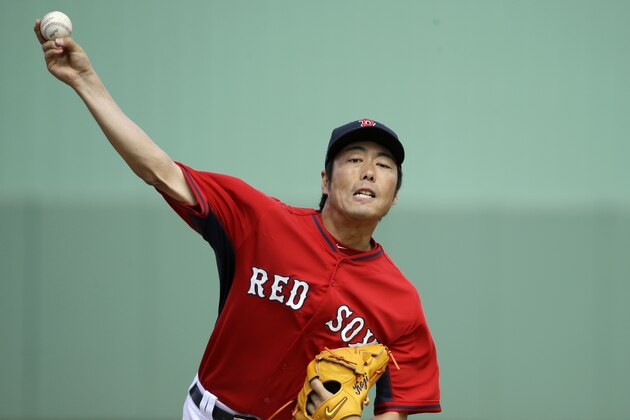 Boston Red Sox's Koji Uehara, of Japan, delivers a warm-up pitch in the fifth inning of an exhibition baseball game against the Atlanta Braves, Friday, March 7, 2014, in Fort, Myers, Fla. The Red Sox won 4-1 over the Braves. (AP Photo/Steven Senne)