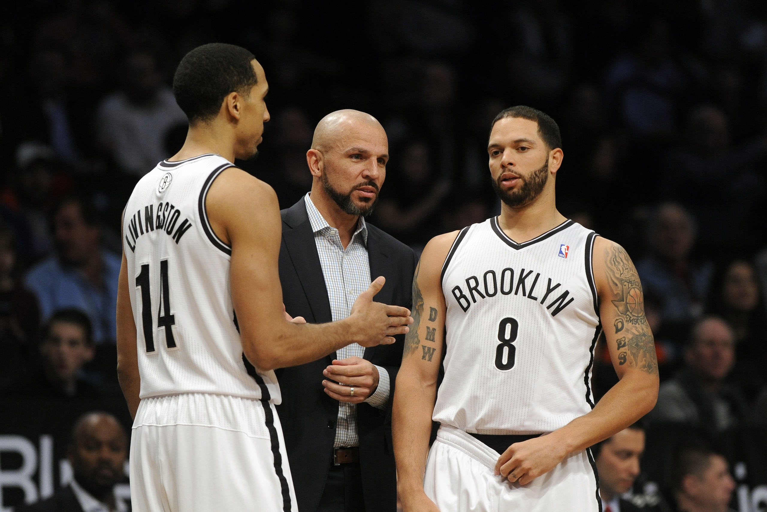 Brooklyn Nets coach Jason Kidd talks with Shaun Livingston (14) and Deron Williams (8) during an NBA basketball game against the Sacramento Kings on Sunday, March 9, 2014 at Barclays Center in New York. (AP Photo/Kathy Kmonicek)