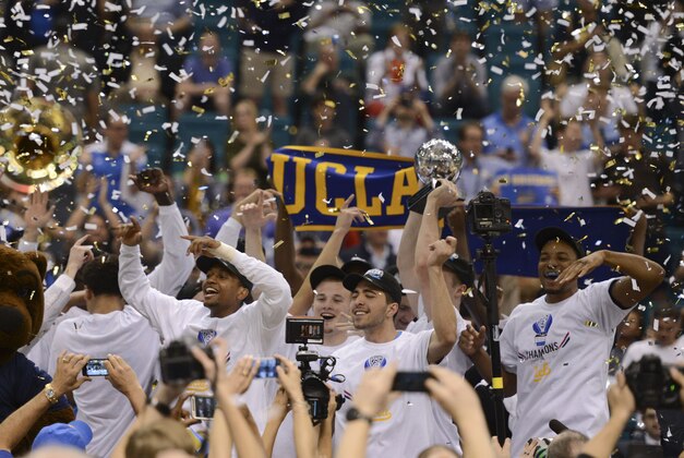 Mar 15, 2014; Las Vegas, NV, USA; UCLA Bruins celebrates with the championship trophy after the championship game of the Pac-12 Conference college basketball tournament against the Arizona Wildcats at MGM Grand Garden Arena. The Bruins defeated the Wildcats 75-71. Mandatory Credit: Kyle Terada-USA TODAY Sports