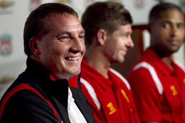 Liverpooll FC manager Brendan Rodgers takes questions from reporters as captain Steven Gerrard, center, and teammate defender Glen Johnson, right, look on during a news conference at Fenway Park baseball stadium, in Boston, Tuesday, July 24, 2012. Liverpool are to play Roma in a friendly soccer game at Fenway Park on Wednesday. (AP Photo/Steven Senne)
