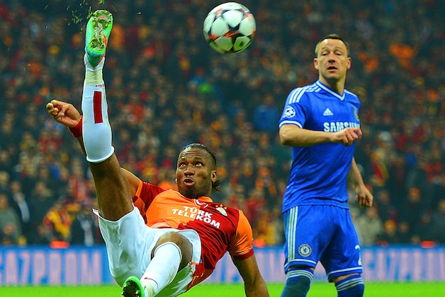 ISTANBUL, TURKEY - FEBRUARY 26:  John Terry of Chelsea looks on as Didier Drogba of Galatasaray clears the ball during the UEFA Champions League Round of 16 first leg match between Galatasaray AS and Chelsea at Ali Sami Yen Arena on February 26, 2014 in Istanbul, Turkey.  (Photo by Michael Regan/Getty Images)