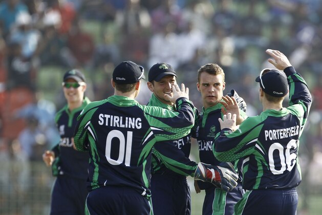 Ireland's Andy McBrine, second right, celebrates with teammates the dismissal of Zimbabwe's Sean Williams during their ICC Twenty20 Cricket World Cup match against Zimbabwe in Sylhet, Bangladesh, Monday, March 17, 2014. (AP Photo/A.M. Ahad)